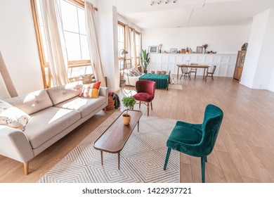 Vintage Studio Apartment Interior In Light Colors In Old Style. Huge Room With Large Windows With A Living Room Area And A Bedroom Area. Direct Sunlight Inside.