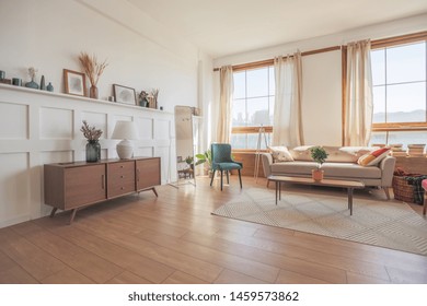 Vintage Studio Apartment Interior In Light Colors In Old Style. Huge Room With Large Windows With A Living Room Area And A Bedroom Area. Direct Sunlight Inside.