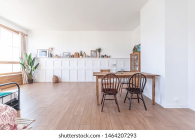 Vintage Studio Apartment Interior In Light Colors In Old Style. Huge Room With Large Windows With A Living Room Area And A Bedroom Area. Direct Sunlight Inside.