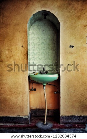 Similar – Morbid mood. A toilet bowl stands in a dilapidated house. Wallpaper and paint come off the wall and through an open window you can see a shrub