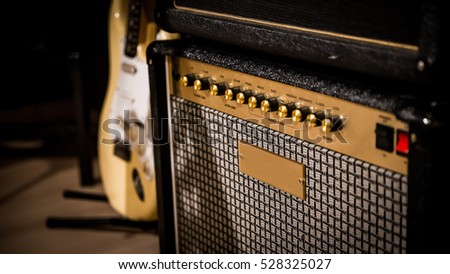 vintage style amp and guitar in the background.