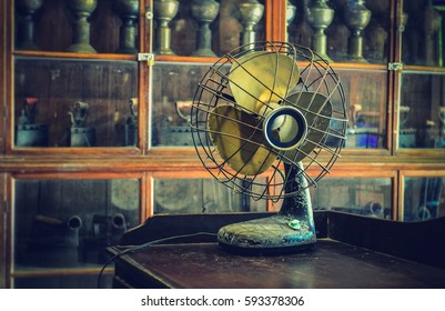 Vintage style antique electric fan retro style on wooden background wallpaper