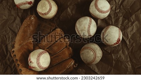 Vintage style baseball banner with used game balls on old glove background.
