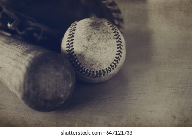 Vintage Style Baseball Image, Great For Rugged Grunge Sports Print.  Sepia In Tone With Old Wooden Bat, Detail Ball Laying Against Glove Of Player.  Great For Athletes, Team, Coach Or Fan.