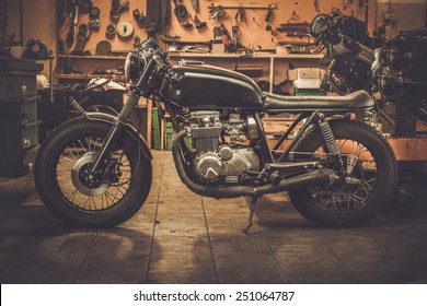 Vintage style cafe-racer motorcycle in customs garage 