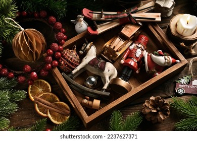 Vintage style Christmas style toys and decors in wooden box on rustic table  - Powered by Shutterstock