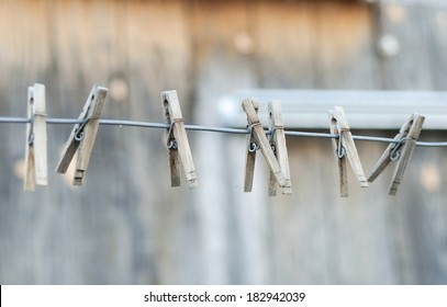 Vintage style clothespins on a metal wire line.