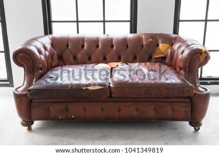 vintage style . Defective old leather sofa on white room