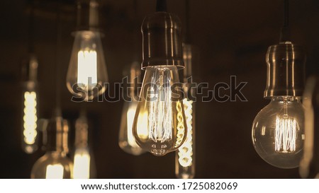 Vintage style light bulbs hanging from the ceiling. Decorative lights at home. Old Edison bulb.