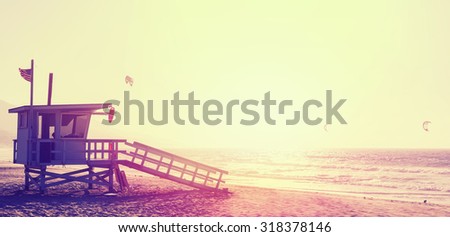 Vintage style picture of lifeguard tower at sunset in Malibu, USA.