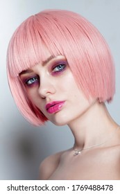 Vintage style portrait of young beautiful woman with pink hair and fancy glitter makeup