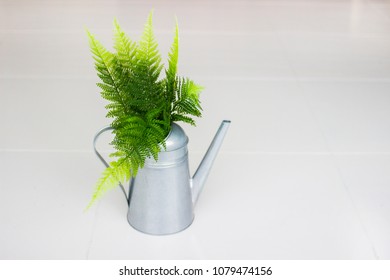 Vintage style watering can. Metal watering can with green fern. - Shutterstock ID 1079474156