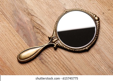 Vintage Style Of Women Hand Mirror On Wooden Desk