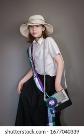 A Vintage Styled Portrait Of A Girl In A Suffragette Costume With Sash And Hat