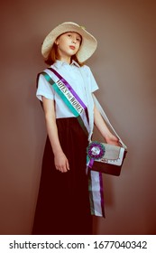 A Vintage Styled Portrait Of A Girl In A Suffragette Costume With Sash And Hat