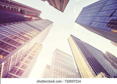 Vintage stylized picture of Manhattan skyscrapers at sunset, looking up perspective, New York City, USA.  - Shutterstock ID 710037214