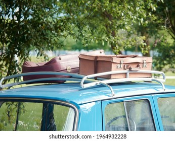 Vintage suitcases on the roof of the trunk of a car, close up look