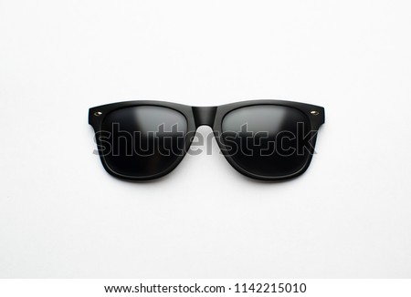 Vintage sunglasses with black plastic frame on white background