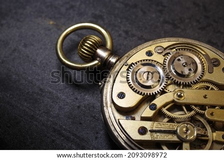 Vintage swiss clockwork mechanism. Silver pocket watch on stone background