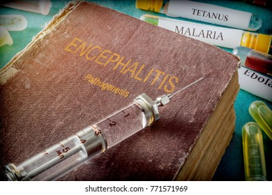 Vintage Syringe On A Book Of Encephalitis, Medical Concept