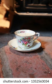 Vintage Teacup Candle On Brick Hearth