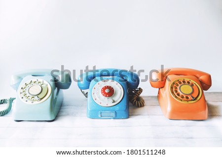 Vintage telephone in white room.