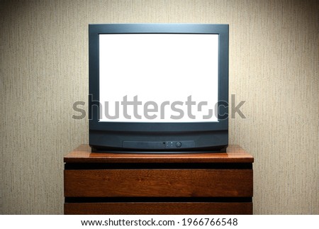 Vintage Television on wooden antique closet, old design in a home.Old black vintage TV with white screen to add new images to the screen.