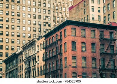 Vintage tenement buildings and modern buildings in the background, New York City