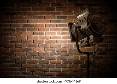 Vintage Theater / Movie Spot Light Focused On A Brick Wall Background