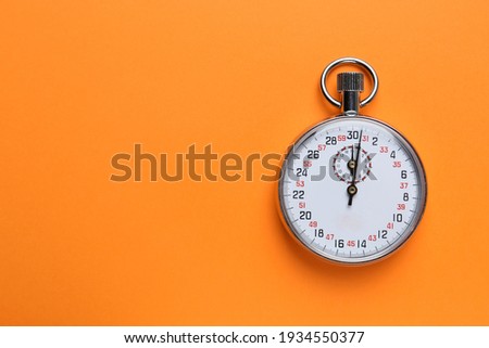 Vintage timer on orange background, top view. Space for text