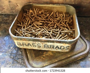 Vintage Tin Of Brass Tacks In The Old Workshop.