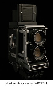 Vintage TLR medium format camera camera, three quarter view on black