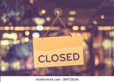 Vintage tone of :A closed sign hanging in a shop window
