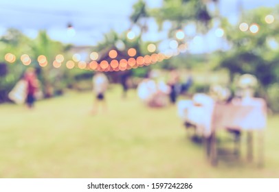 Vintage Tone Abstract Blur Image Of People In  Banqueting Outdoor Party With Bokeh For Background Usage .