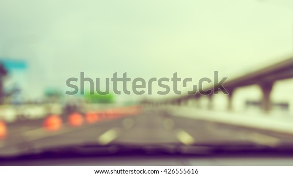 vintage tone abstract blur image of\
inside cars with bokeh on day time for background usage\
.
