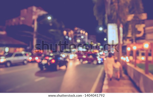 Vintage tone\
abstract blurred image of People walking at footpath in night time\
with light bokeh  for background\
usage.