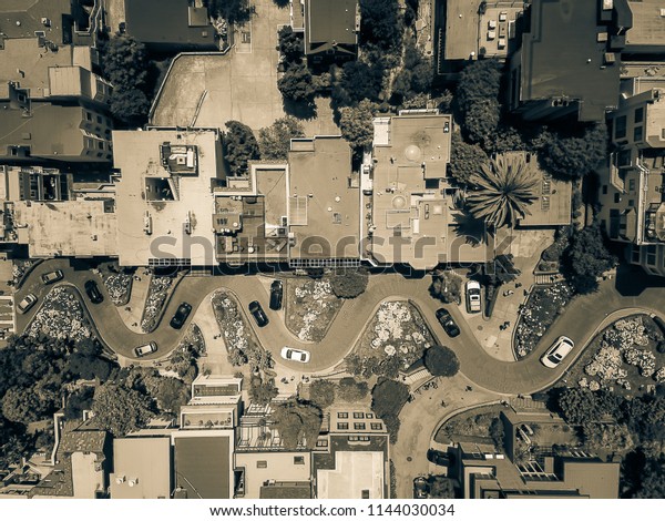 Vintage tone aerial Lombard Street, an east–west\
street in San Francisco, California. Famous for steep, one-block\
section with eight hairpin turns. Crookedest, steep hills, sharp\
curves, one-way road