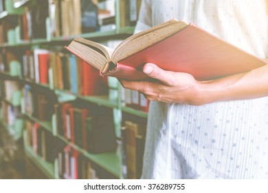 Vintage Tone Of Asia Woman Reading Book In Library .Retro Filter Effect,soft Focus,low Light.(selective Focus)
