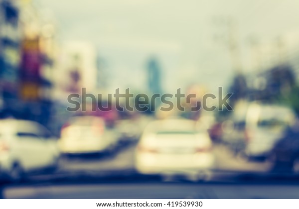 vintage tone blur image of inside cars\
with bokeh on day time for background usage\
.