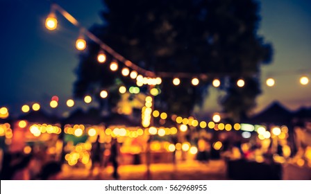 Vintage Tone Blur Image Of Night Festival On Street With Bokeh For Background Usage .