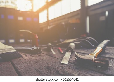 Vintage tone of equipment on wooden desk with workshop background. Retro filter effect, low light, selective focus. - Powered by Shutterstock