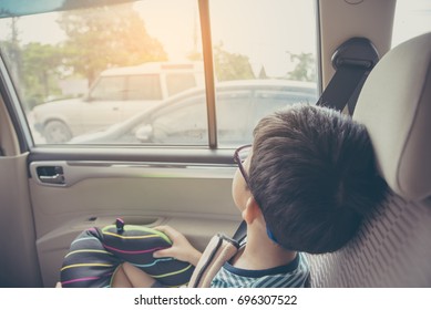 Vintage Tone Image Of Asian Kid  Sit On Back Seat In Car And Look To Outside For Background Usage.