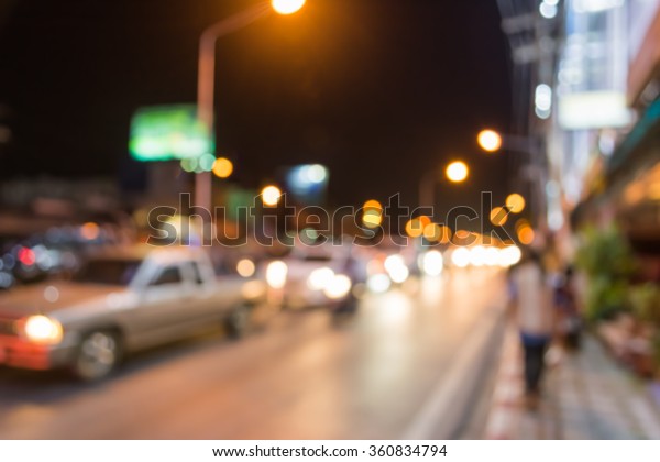 vintage tone image of blur street\
bokeh with colorful lights in night time for background usage\
.