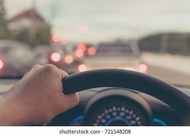 vintage tone image of people driving car on day time for background usage.(take photo from inside focus on driver hand) - Shutterstock ID 721548208