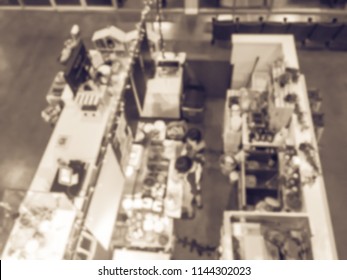 Vintage Tone, Motion Blurred Top Down View Compact Juice Bar And Café In US Shopping Mall. Blurry Food Kiosk Booth Counter With Bartenders Mixing The Beverage