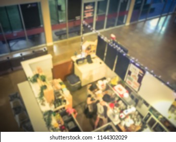 Vintage Tone, Motion Blurred Top Down View Compact Juice Bar And Café In US Shopping Mall. Blurry Food Kiosk Booth Counter With Bartenders Mixing The Beverage