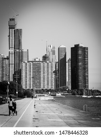 Vintage Tone Rear View Of Fit Asian Lady Running Pushing Stroller Along Shoreline Of Michigan Lake With Downtown Chicago Skylines In Background. Fit Sportswear Woman Exercise Outdoor At Fall Daytime