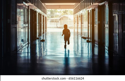 vintage tone silhouette image of kids running in school hall way.