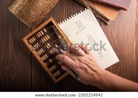 Vintage tone of women's hands doing accounting with old accounts . financial concept.