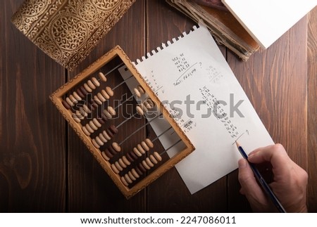 Vintage tone of women's hands doing accounting with old accounts . financial concept